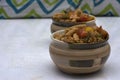 Two bowls of Italian pasta with bell papers on a white background