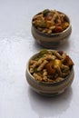 Two bowls of Italian pasta with bell papers on a white background