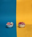 Two bowls of rahat lakoum isolated on blue and yellow background. Turkish sweet concept Royalty Free Stock Photo