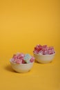 Two bowls of rahat lakoum isolated on yellow background. Turkish sweet concept Royalty Free Stock Photo