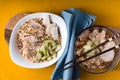 Two bowls of soup noodle ramen, celery, chicken on a yellow table Royalty Free Stock Photo