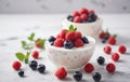 Two bowls of yogurt topped with raspberries and blueberries on a table Royalty Free Stock Photo