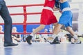 Boxing in the ring. On the foreground boxers legs. Horizontal image. Royalty Free Stock Photo