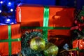 Two boxes of Christmas gifts surrounded by Christmas decorations
