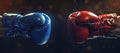 Two boxing gloves in a face-off, symbolic confrontation. red vs blue, sports equipment still life on dark background Royalty Free Stock Photo