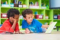 Two boy kid lay down on floor and reading tale book in preschoo Royalty Free Stock Photo