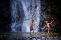 Two boy laugh fishing at a waterfall countryside thailand.Fishing boy asian by gaff in creek with beautiful background