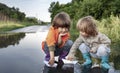 Two boy play in paper ship in puddle summer day Royalty Free Stock Photo