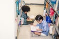 Two boy reading on the library floor Royalty Free Stock Photo