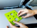 Two boy& x27;s hand playing tic-tac-toe game or noughts and crosses inside in airplane in the commercial jet airplane Royalty Free Stock Photo