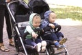 Two boy twins in a stroller in the street Royalty Free Stock Photo