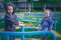 Two boys in blue jackets ride