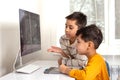 Two boys  boys doing their homework with a computer. They drawing on a computer using a tablet Royalty Free Stock Photo