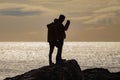 Two boys checking photos captured with a mobile phone at the beach Royalty Free Stock Photo