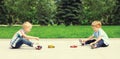 Two boys children playing together with toys cars in the park on summer day