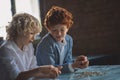 Two boys counting coins and looking busy Royalty Free Stock Photo