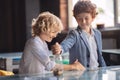 Two boys counting coins and putting them to the jar Royalty Free Stock Photo
