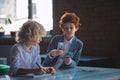 Two boys counting money and looking busy Royalty Free Stock Photo