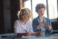 Two boys counting money and making notes Royalty Free Stock Photo