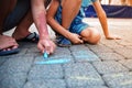 Two boys draw with chalk on the pavement. The concept of a happy childhood Royalty Free Stock Photo