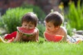 Two boys, eating watermelon in the garden Royalty Free Stock Photo