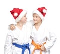 Two boys embrace in a kimono and wearing Santa hat