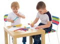 Two boys enthusiastically paint markers