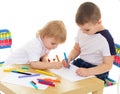 Two boys enthusiastically paint markers