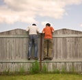 Two boys on the fence looking for smth Royalty Free Stock Photo