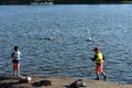 Two boys fishing from the lake