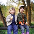 Two boys on the forest bench Royalty Free Stock Photo