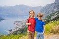 Two boys friend enjoys the view of Kotor. Montenegro. Bay of Kotor, Gulf of Kotor, Boka Kotorska and walled old city