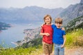 Two boys friend enjoys the view of Kotor. Montenegro. Bay of Kotor, Gulf of Kotor, Boka Kotorska and walled old city