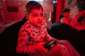 Two boys gamers play gamepad video game console in red gaming room Royalty Free Stock Photo