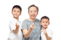 Two boys and grandmother showing mini heart sign, family caring and love
