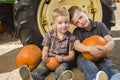 Two Boys Having Fun at the Pumpkin Patch on a Fall Day