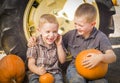 Two Boys Having Fun at the Pumpkin Patch on a Fall Day