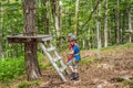 Two boys in a helmet, healthy teenager school boy enjoying activity in a climbing adventure park on a summer day Royalty Free Stock Photo