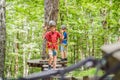 Two boys in a helmet, healthy teenager school boy enjoying activity in a climbing adventure park on a summer day Royalty Free Stock Photo