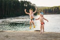 Two boys jumping on the lake Royalty Free Stock Photo