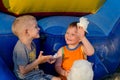 Two boys laughing as they share cotton candy Royalty Free Stock Photo