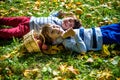 Girl and two boys lay on the grass and eat apples Royalty Free Stock Photo