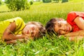 Two boys laying on the grass together in park Royalty Free Stock Photo