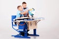 The two boys are learning globe for desk at school Royalty Free Stock Photo