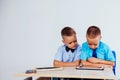 The two boys are looking at Internet Tablet school Royalty Free Stock Photo