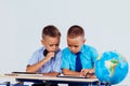 The two boys are looking at Internet Tablet school Royalty Free Stock Photo