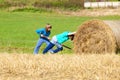 Two Boys Moving Bale of Hay