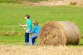 Two Boys Moving Bale of Hay