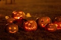 Two boys in the park with Halloween costumes, carved pumpkins with candles and decoration Royalty Free Stock Photo