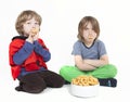 Two boys with peanut puffs Royalty Free Stock Photo